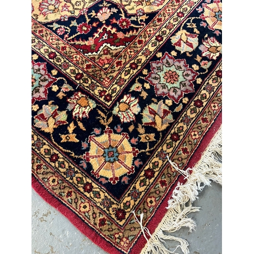 627 - Large Middle Eastern Mashad type carpet, on a red ground with central floral medallion and foliate a... 