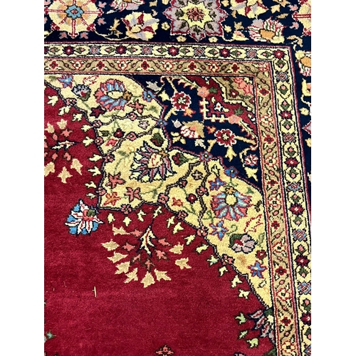 627 - Large Middle Eastern Mashad type carpet, on a red ground with central floral medallion and foliate a... 