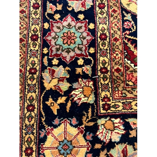 627 - Large Middle Eastern Mashad type carpet, on a red ground with central floral medallion and foliate a... 