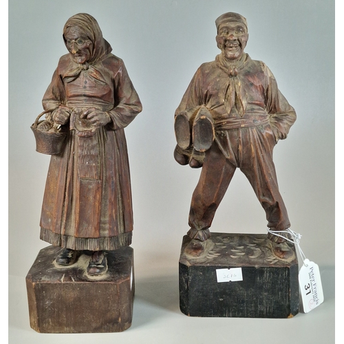 31 - Pair of European carved softwood figures of a jovial man and an old lady. 25cm high approx. (2) (B.P... 