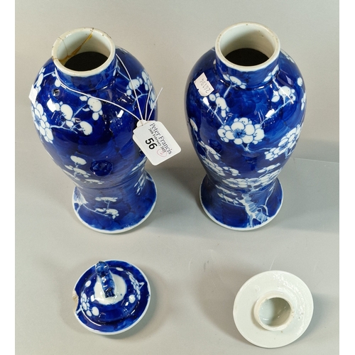 56 - A pair of export Chinese porcelain under glazed blue baluster shaped vases and covers decorated with... 