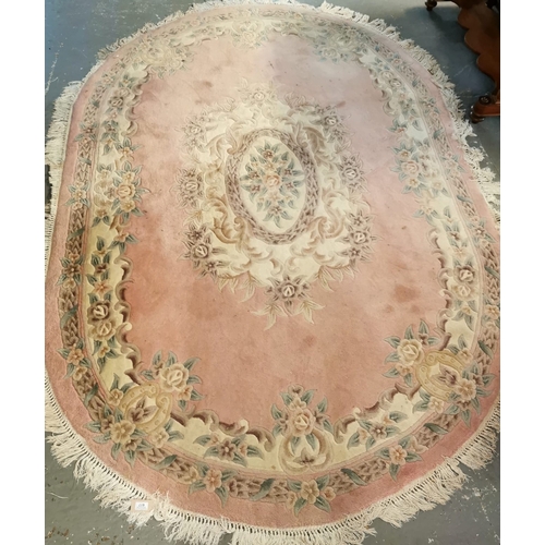 617 - Modern Chinese washed ground floral and foliate pink ground carpet of oval form. 276x186cm approx. T... 