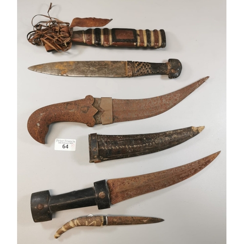 64 - Group of four Middle Eastern style daggers, two with sheaths. Distressed condition. (4) (B.P. 21% + ... 