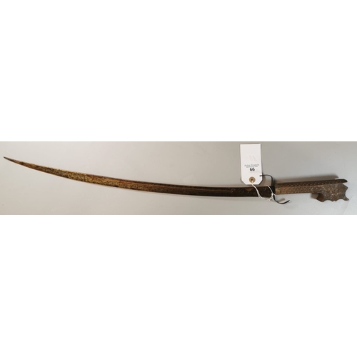 66 - Probably Indian curved sword with single edged engraved blade, plain steel guard and chip carved woo... 