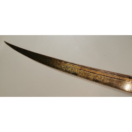 66 - Probably Indian curved sword with single edged engraved blade, plain steel guard and chip carved woo... 