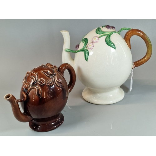 9 - Two unusual novelty ceramic teapots, one brown glazed, the other on a white ground, both with raised... 