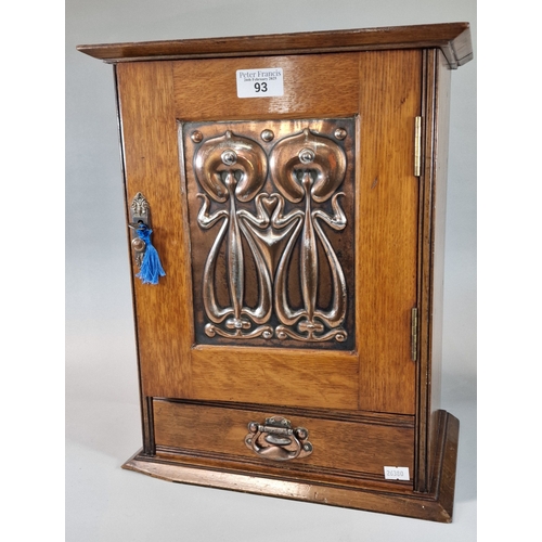 Art Nouveau oak single door smoker's cabinet, the moulded hinged cornice above copper organic design panel, the interior revealing fitted compartments with under drawer. 39.5x19x40cm approx. (B.P. 21% + VAT)