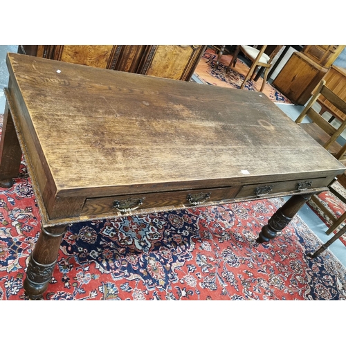 17 - Early 20th century stained oak side/serving table, having two frieze drawers to one side and standin... 