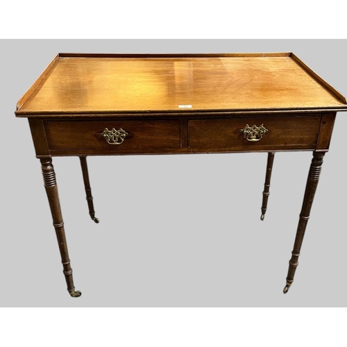 18 - Early 19th century mahogany side table/writing desk, the moulded gallery top above two drawers, stan... 