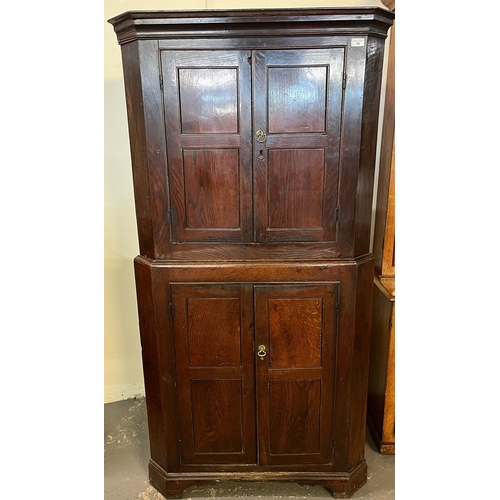 36 - Late 18th century Welsh oak two stage corner cupboard, the moulded cornice above two blind panelled ... 