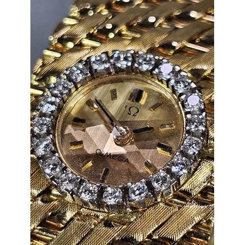 465 - A Spectacular 18ct gold and diamond ladies' Omega cuff watch, having gilt face with Baton numerals a... 