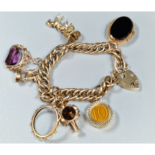 9ct gold curb-link charm bracelet with an assortment of gold charms including: carriage lamp,  ram, heart shaped locket, horse and cart etc. 48.6g approx. (B.P. 21% + VAT)