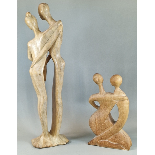 24 - Two hardwood stylised figure groups of male and females. (2) (B.P. 21% + VAT)