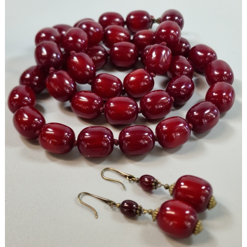 Cherry Amber type beaded necklace, together with a pair matching earrings. 189g approx. The beads, all 2cm long approx. (B.P. 21% + VAT)