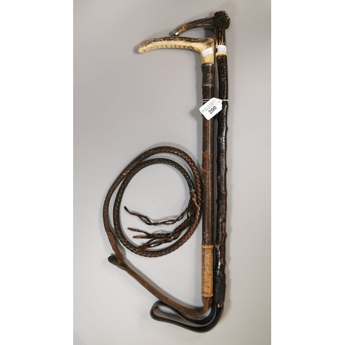 Two vintage riding crops, both with bone handles and white metal mounts ...