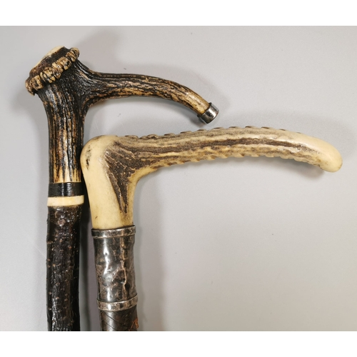 Two vintage riding crops, both with bone handles and white metal mounts ...