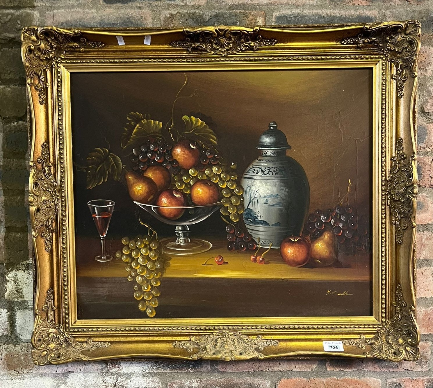 Modern still life study of fruit in a basket with a glass of wine ...