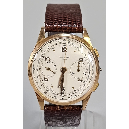 An 18ct gold Swiss gentleman's chronograph wristwatch (Chrongraphe Suisse), having cream face with Arabic numerals, centre sweep seconds hand and two subsidiary dials, on leather strap. 39mm diameter approx. Overall 45g approx. (B.P. 21% + VAT)