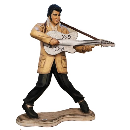 Modern composition Elvis Presley statue playing a guitar, on serpentine moulded base bearing label 'Made in Philippines'. 94cm high approx. (B.P. 21% + VAT)