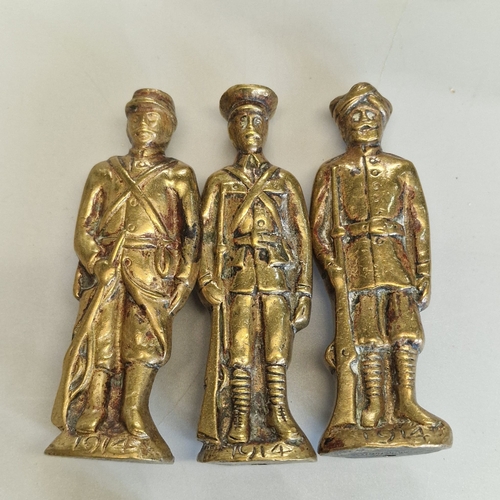 Trench art, comprising three WW1 brass soldier figures, each dated 1914 ...