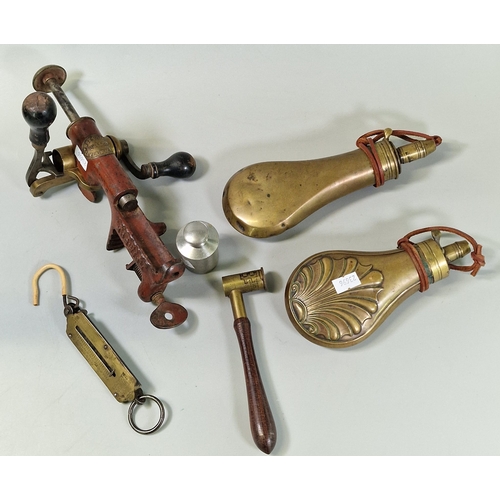 Two brass shot flasks, a powder measure, brass scales, an aluminium oil ...