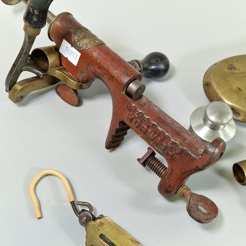 Two brass shot flasks, a powder measure, brass scales, an aluminium oil ...