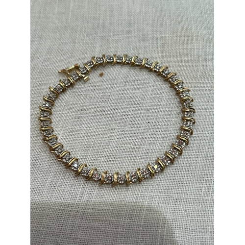 379 - 18CT AND DIAMOND TENNIS BRACELET