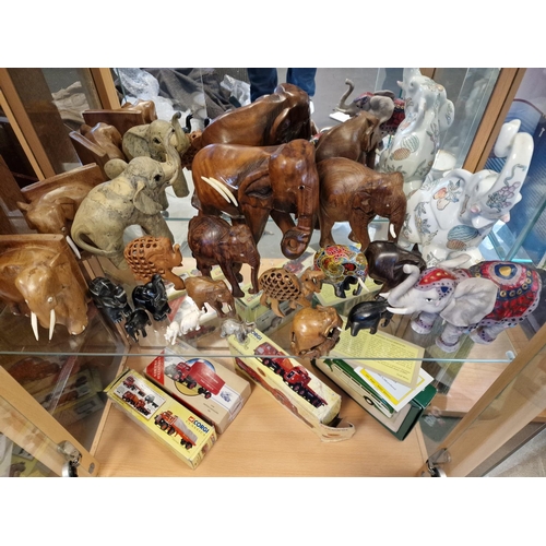 49d - Shelf of Various Indonesian and Other Wooden and Ceramic + Stone Elephants