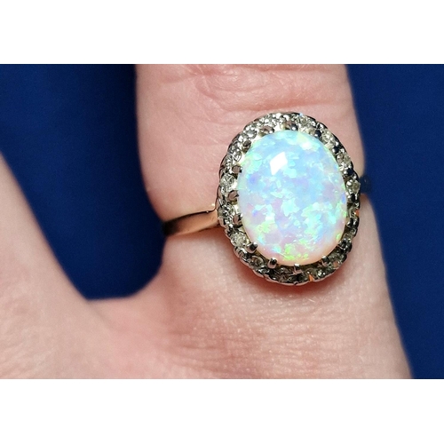 56 - 9ct Gold, Opal & Diamond Dress Ring. Size K and weighs 2.9g approx