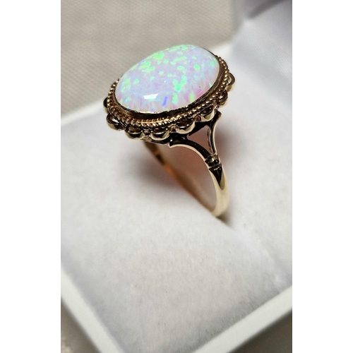 57 - 9ct Gold & Opal Dress Ring,  set with single opal (measures 14x10mm approx). Size R and weighs 2.6g ... 