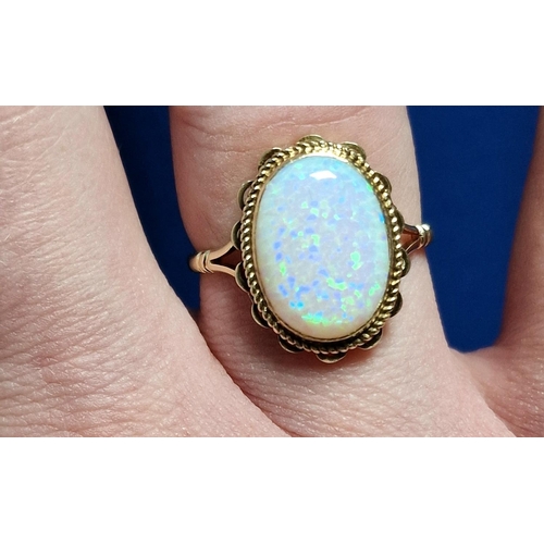 57 - 9ct Gold & Opal Dress Ring,  set with single opal (measures 14x10mm approx). Size R and weighs 2.6g ... 