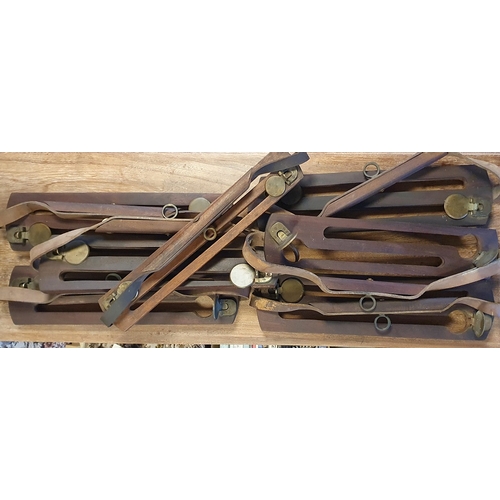 417 - 7 wooden game holders with leather straps and brass stops, together with a brass Salter's Improved C... 