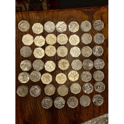 145f - Various 50p Currency Coins w/collectable artworks like Beatrix Potter and D-Day etc - £40 face value