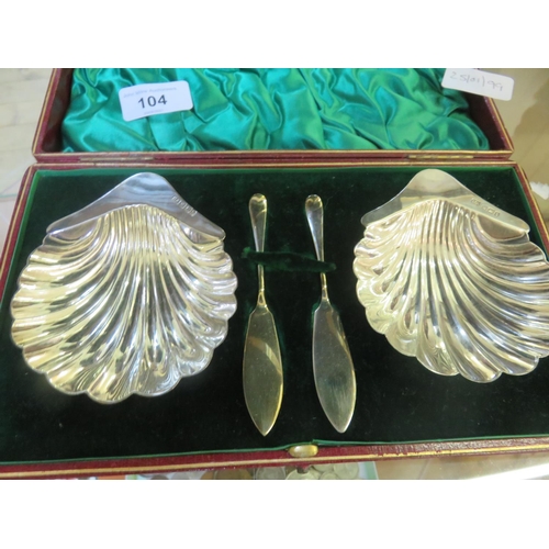 104 - Pair of Cased Sheffield silver Scallop shaped Butter Dishes and Knives