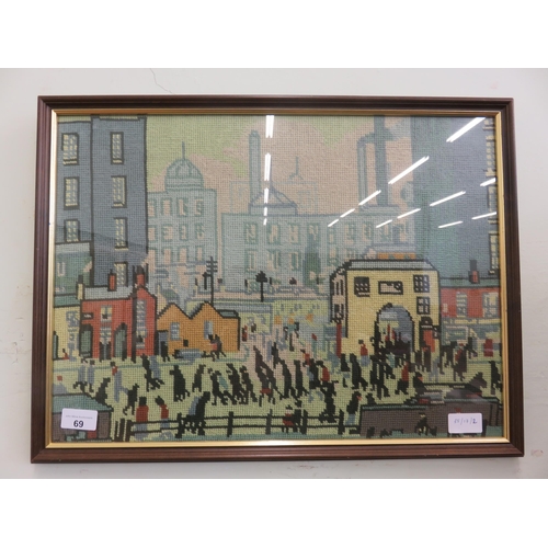 69 - Framed Village Needlecraft picture in style of L.S. Lowry