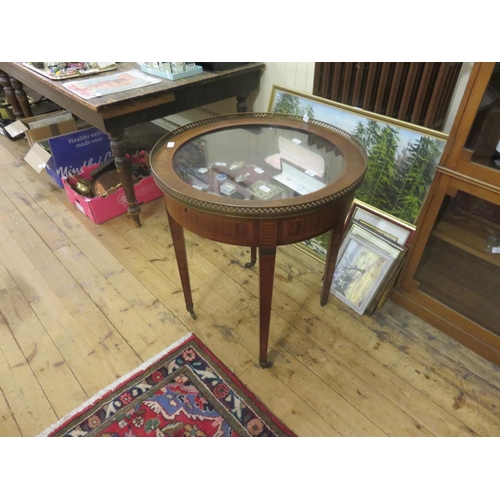 486 - Circle Specimen Table on Tapered legs with castors, glass top with brass border