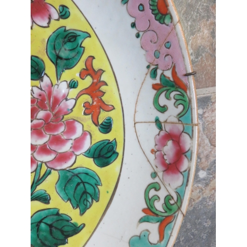 265 - Chinese Famille Rose Design Wall Charger on Yellow Ground with repairs, 14 inches Diameter.