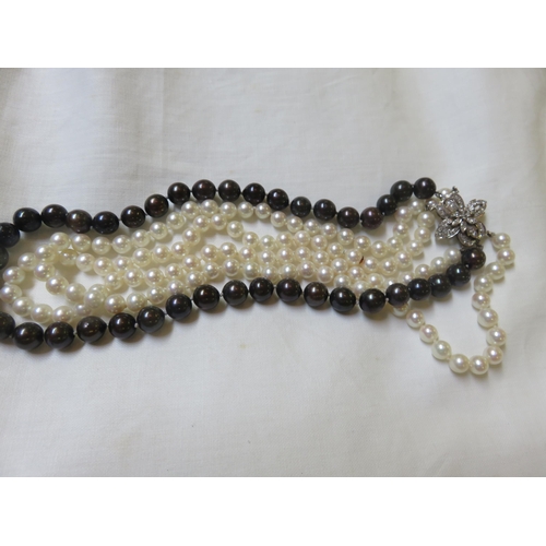 64 - Three strand cultured Pearl Necklace with large 14ct. Gold Diamond Clasp