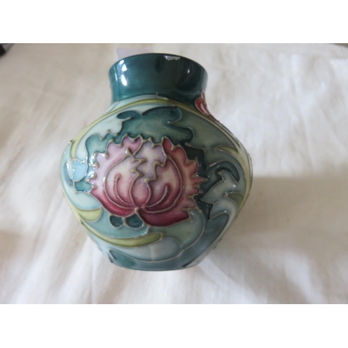 69 - Small Moorcroft Vase with floral design on green ground