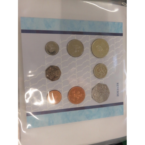 129 - Album with various Coin Sets including £5 Coins