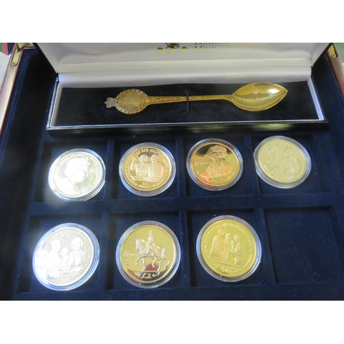 61 - Case containing 11 Silver Gilt Commemorative Coins and a Silver Gilt Spoon