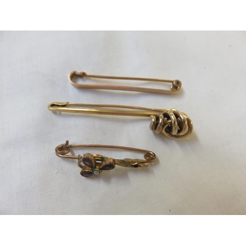 101 - 14ct gold bar brooch, 9ct gold bar brooch and one other