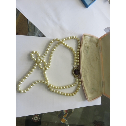 140 - Two strand Pearl Necklace with large Silver-Gilt Gem clasp