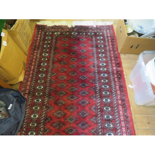 275 - Fringed Rug on red ground, all over medallion design, 63