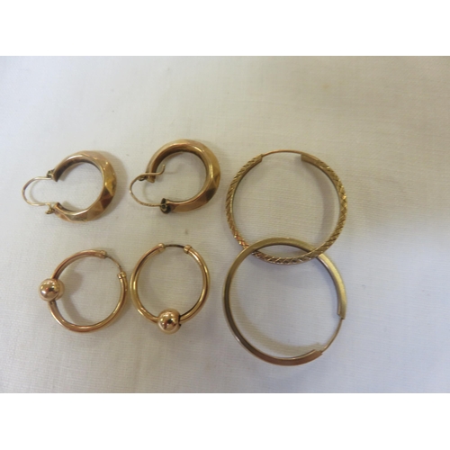 74 - Three sets of Gold and Yellow Metal Hooped Earrings