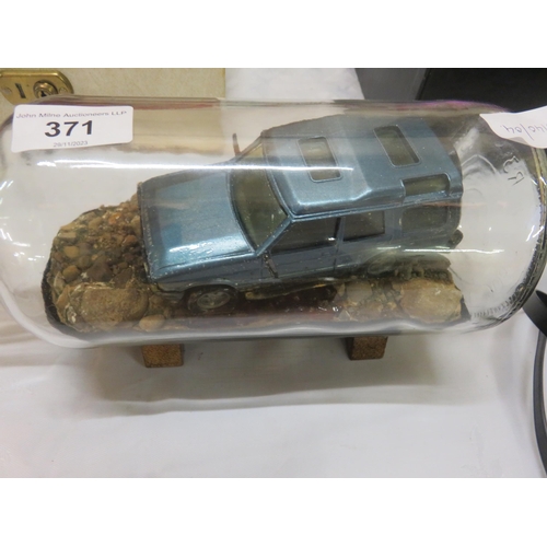 371 - Car in bottle on stand