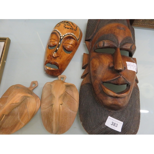 383 - Two Tribal Face Masks and Pair of Wooden Elephant Wall Hangings