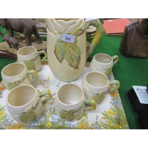 292 - Clarice Cliff Jug and six matching cups