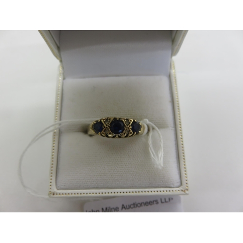 74 - 9ct Gold and Sapphire Type Three Stone Ring