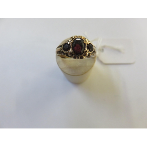 61 - 9ct. Gold three Red Stone Dress Ring